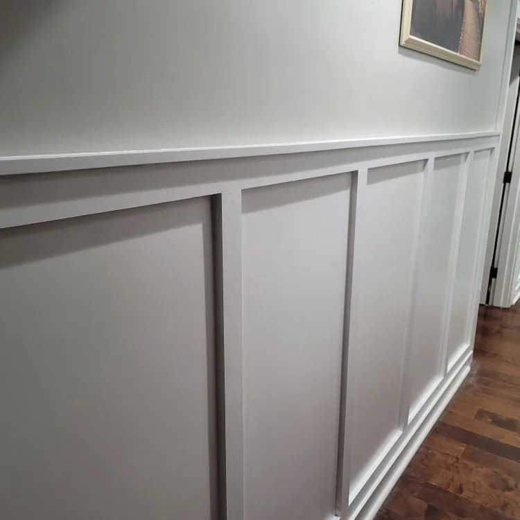 Wainscoting and painted trim along a hallway wall
