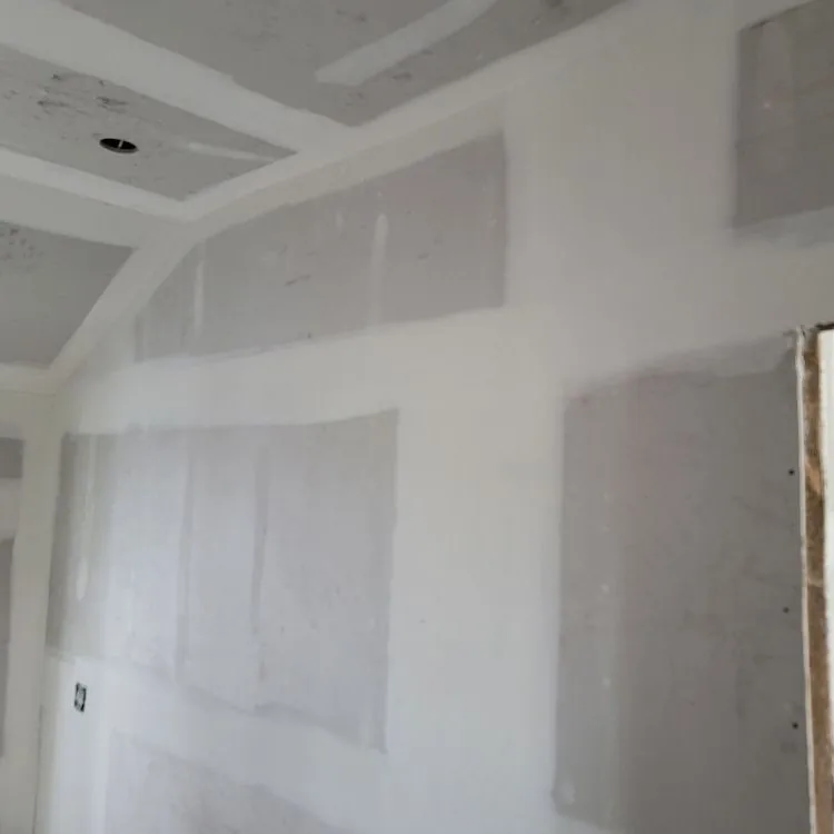 Drywall hung and taped across a tray ceiling and walls