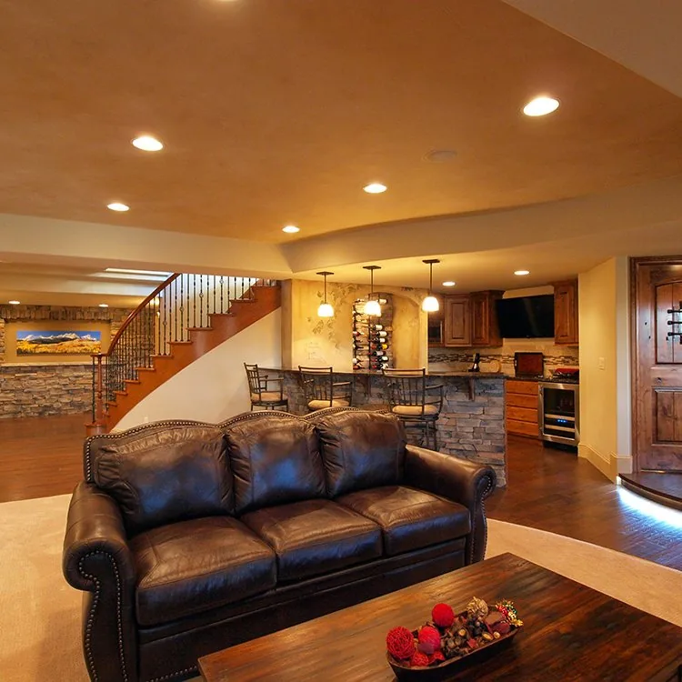 Finished lower level with a bar, seating, and accent lighting